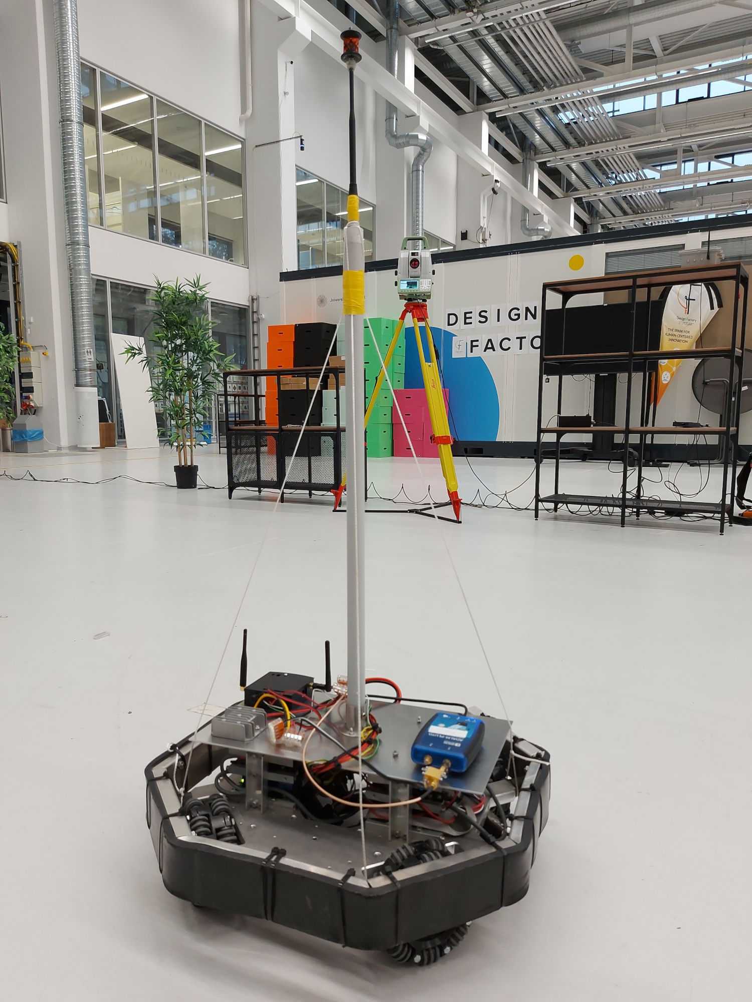 The robot with an ADALM-Pluto SDR as main transmitter and the antenna on top of a pole.